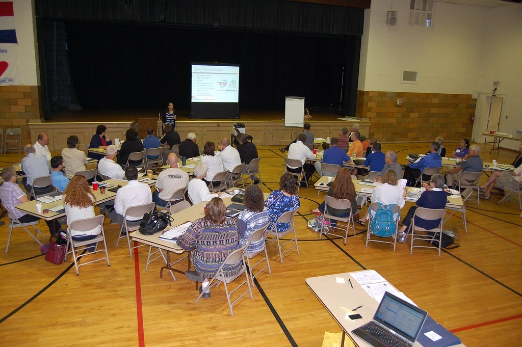 Residents seated at tables during a community planning workshop held in Concordia, Missouri